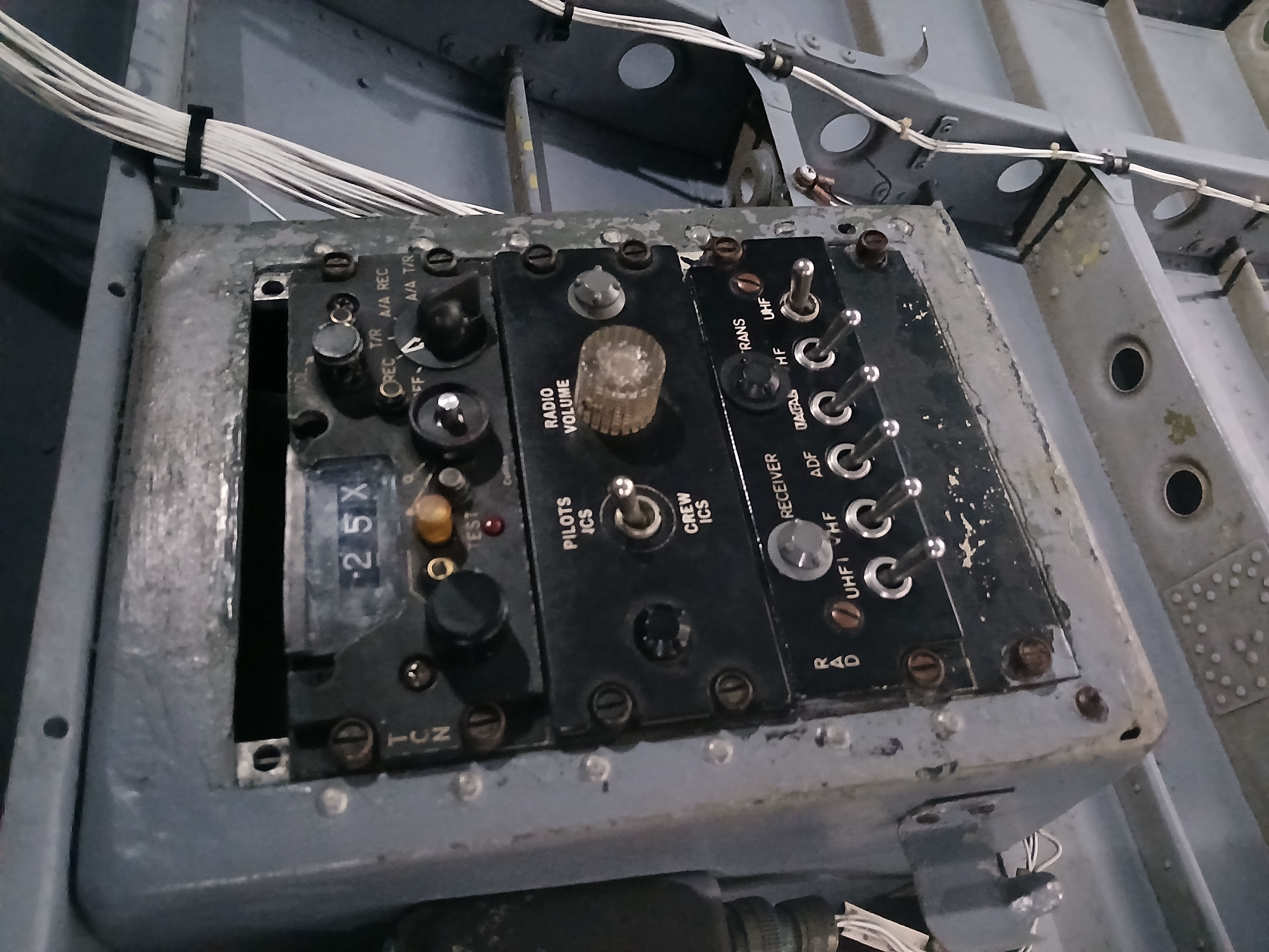 A control panel on the wall inside of a helicopter.