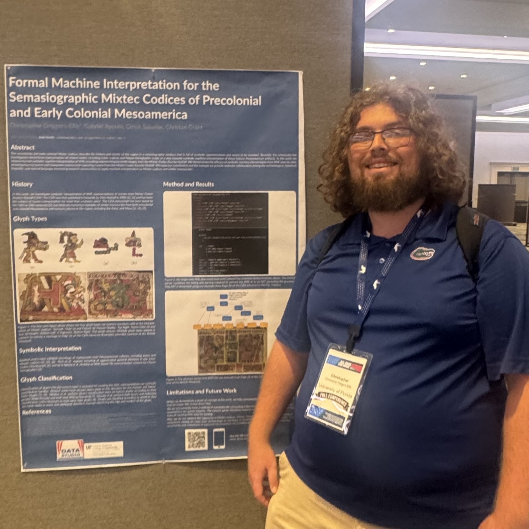 A photo of Christopher from the UF Data Studio standing next to a poster for his paper about parsing for the Mixtec Codices of Precolonial and Early Colonial Mesoamerica.